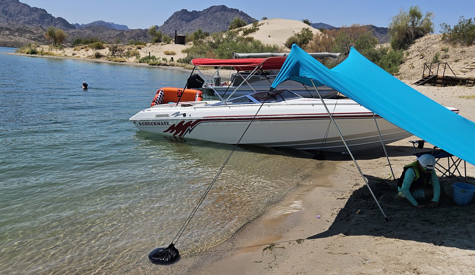 Checkmate performance boat beached on a desert lake